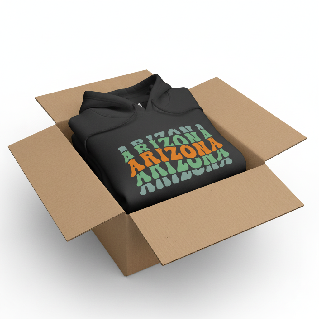 Black hoodie in shipping box with collar and hood visible