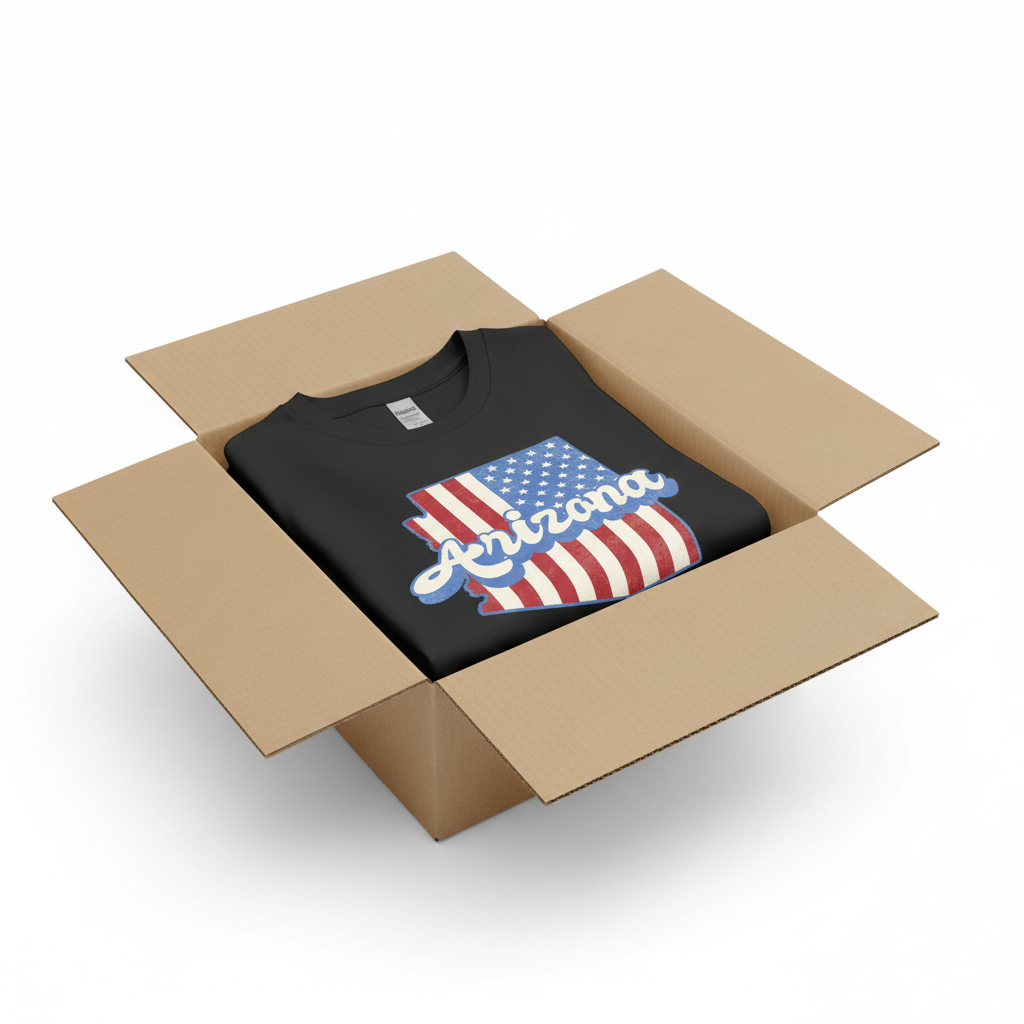 Black t-shirt in shipping box with collar visible